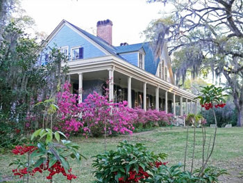 Spanish moss and blooming shrubs soften and hush the front porch of the Butler Greenwood plantation home. Photo by Henry Cancienne.