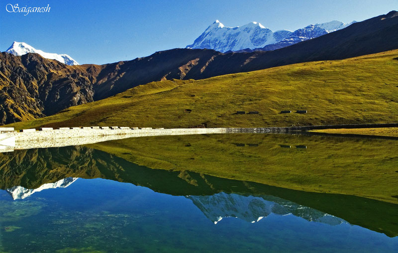 Nandaghunti and Trishul reflected over the placid waters of the sacred Bedni kund in Uttarakhand, India