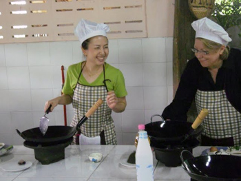 Pam, left, teaches at Baan Hongnual Cookery School in Thailand.