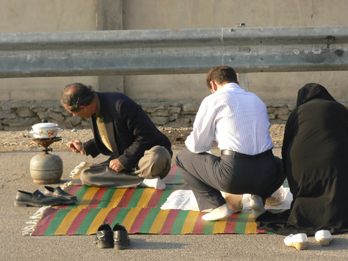 Picnicking is an Iranian tradition...here a family sets out their food right next to a highway toll plaza outside of Tehran. 