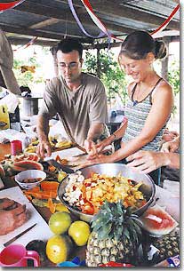 Green Tortoise passengers cooperate in fixing fresh food at their campsites.