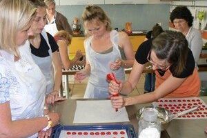 Making macarons, a famous cookie, in a baking class taught all in French in Tours, France.