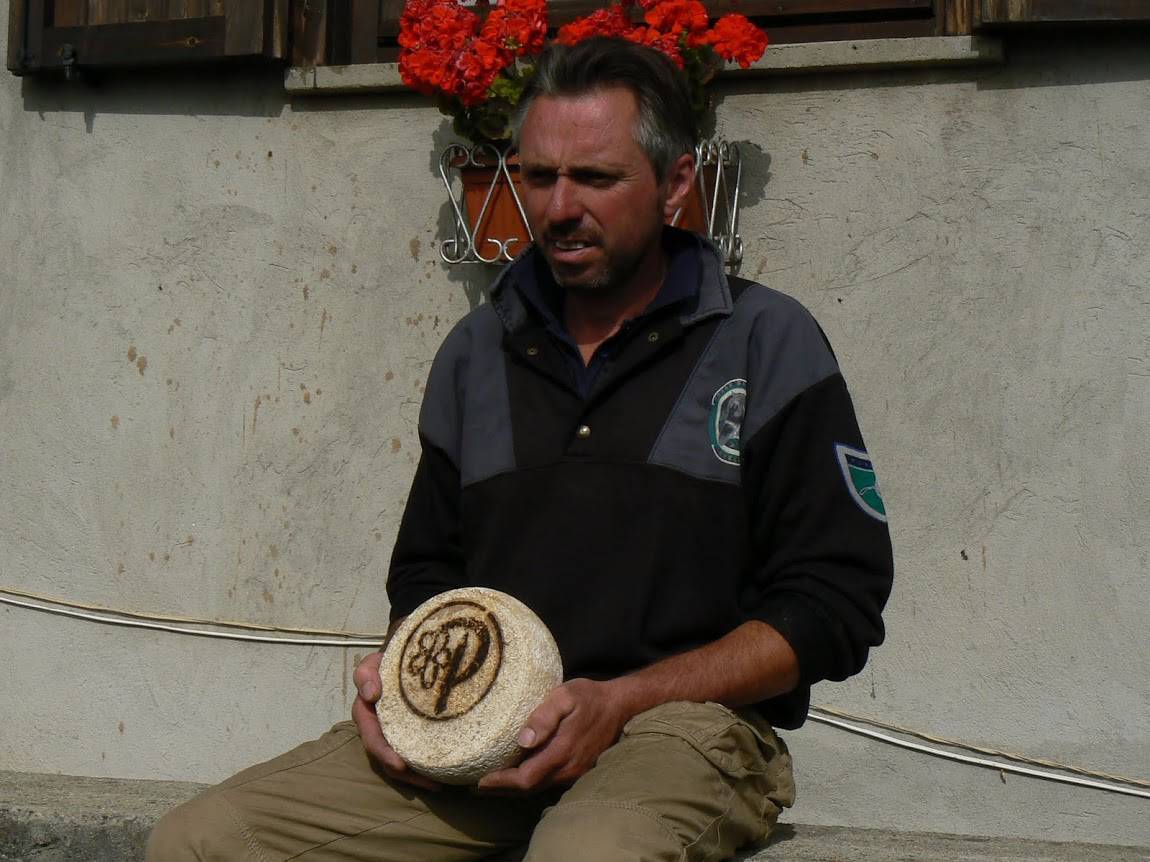 A local cheesemaker shows us his goat cheese in the Alps.