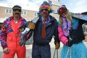 Visitors take note skiing the Wasatch Mountains on Clown Day. Skiers descend the slopes dressed to impress in grass skirts, striped neckties and red sponge noses. Sonja Stark photos.