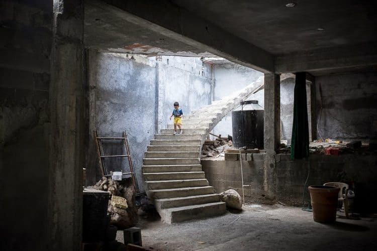 A boy descends a staircase in an unfinished church in Monterrey Mexico. Andy Chambers photo.