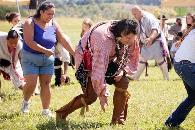 Cherokee Indians performing the Traditional Bear Dance with festival attendees participating