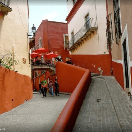 Bridge forming an unusual outdoor patio for a cafe overlooking a callejone.