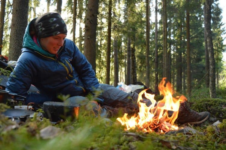 Enjoying a campfire while wild camping in Sweden.