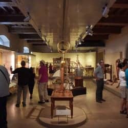 A few people bustling around the exhibitions inside the museum.