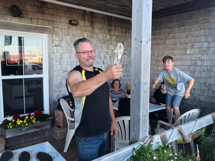 Eric Wagner holds up a "PEI Hammer" at his daughter Courtney's waterfront restaurant, The Catch, in West Point, PEI. 