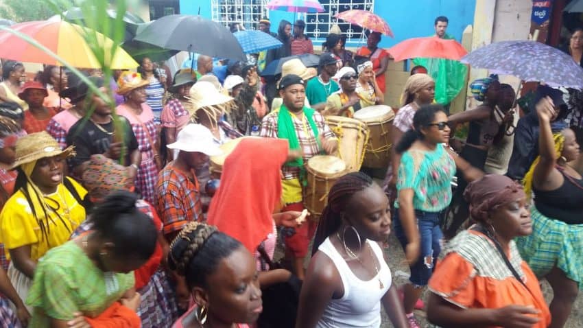 Throngs of happy Garifuna marchers play their native drums, chant and sing in the streets of Livingstone, Guatemala -- rain or shine -- on Garifuna Settlement Day.