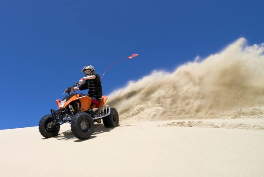 Teen riding ATV in Oceano Dunes State Vehicle Recreation Area