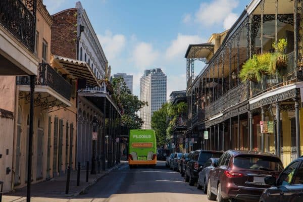 A Flix bus navigates a southern city.