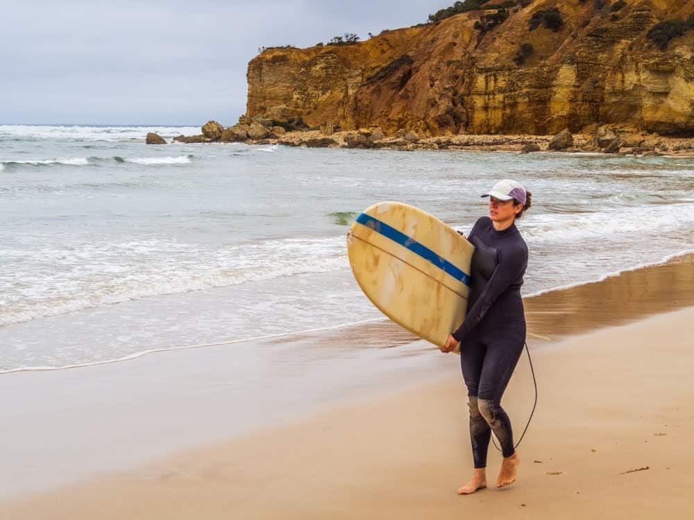 A Surfer getting ready to catch some waves at Lorne Beach.