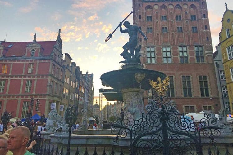 The 17th-century Neptune Fountain is a busy tourist gathering spot in Gdansk, Poland.