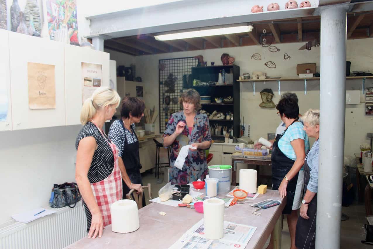 Travelers learning about ceramics in Belgium. Photo courtesy of VAWAA.