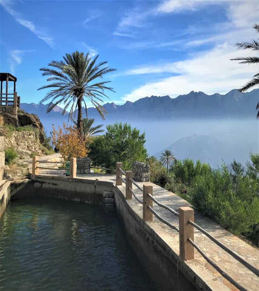 views of date trees and the mountains in Wakan, Oman