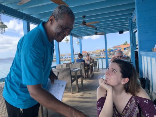 Edwin at the Divi Flamingo resort's Chibi Chibi Restaurant enchants a guest (Jackie Mullen) with options