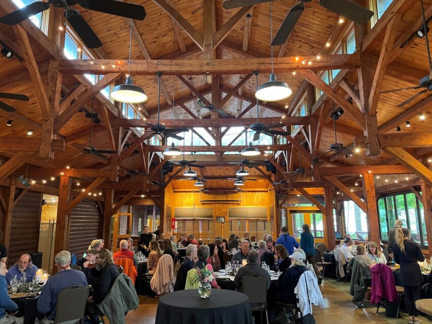 The main dining room for groups staying at Adventures on the Gorge is a beauty with natural wood and large windows looking out onto wilderness.