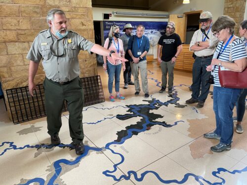 A national park ranger points out the nine rivers that make up the New River water basin. The entire floor of the information center near Hinton is a giant map of the river basins.