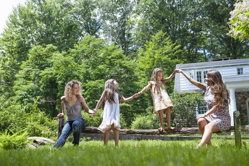 Family playing in the garden in summer.