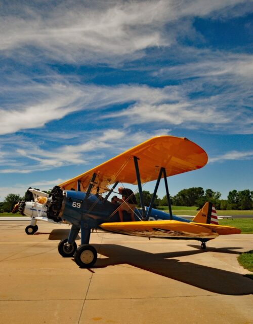 Biplanes sit outside Stearman Field Bar & Grill after taking visitors up for a flight. 