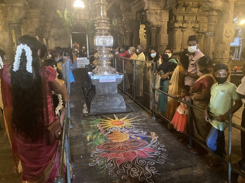 Visitors admired the central kolam with its elaborate details and colored chalk as they waited for a chance to pray in front of the main shrine.