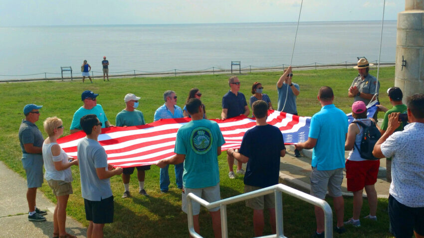 Kathy Hosek (far Left) and 14 volunteers prepare to raise the flag over Fort Sumter