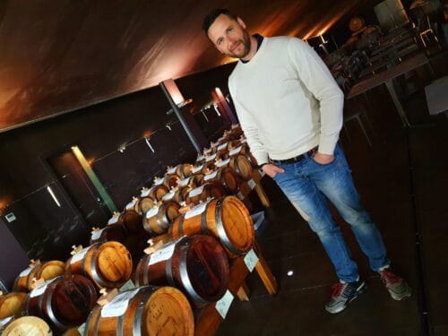 Opera02's Mattia Montanari proudly standing beside his vats of balsamic vinegar