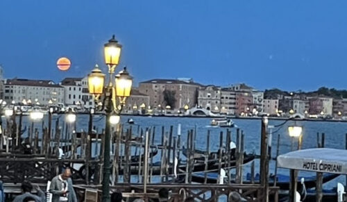 A magnificent full moon rose to join the glowing street lamps illuminating the basin.