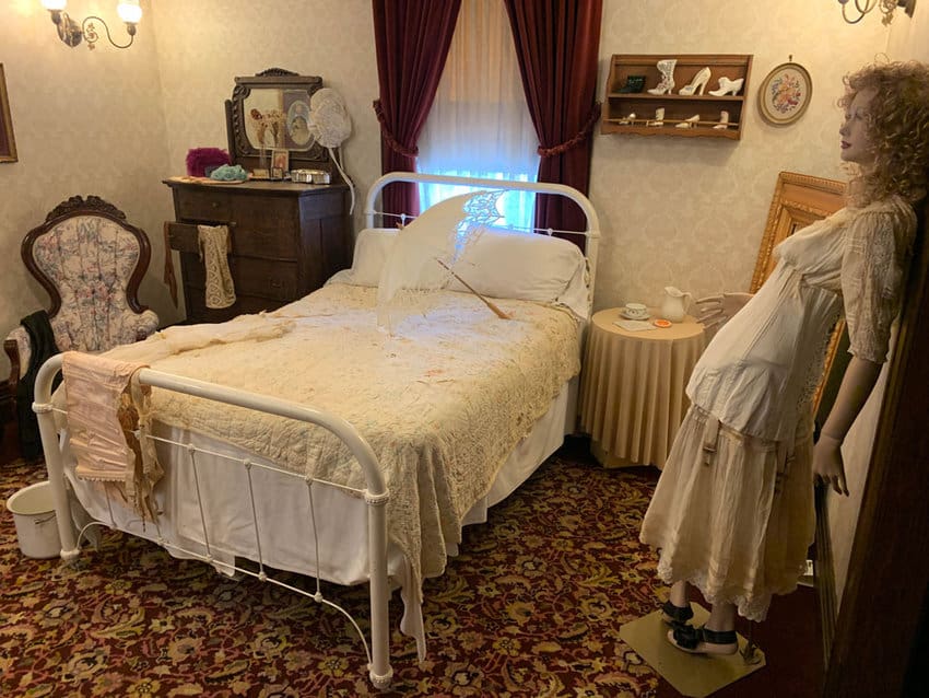 Reminders of the Fort Smith Visitor Center's past as a house of ill repute during the Old West are seen in the period-era decorations, like photos of the women who once worked there.