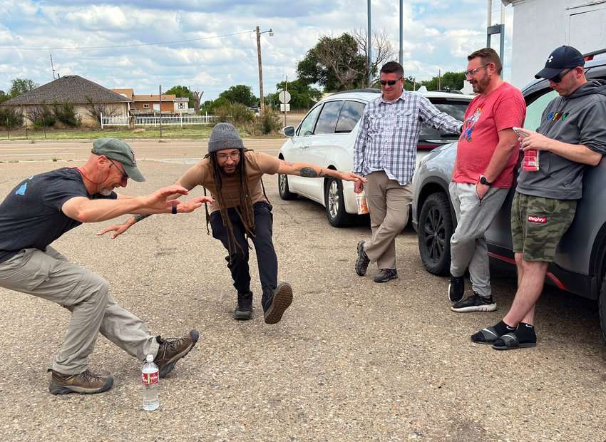 Storm chasers kill time by indulging in friendly competitions like "How far down can you go without falling over!"