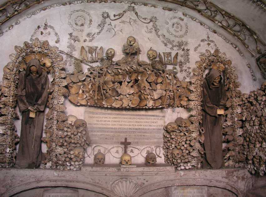 The eerie Capuchin Crypts, are decorated with the bones of Capuchin friars. This image shows two skeletons dressed in the brown habits of the Capuchin order.