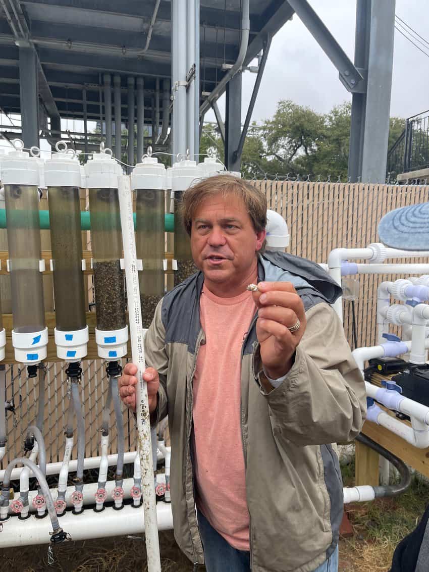 Captain Mike Moore with a baby oyster and his device to raise them for breeding along the Gulf coast.Captain Mike Moore with a baby oyster and his device to raise them for breeding along the Gulf coast.