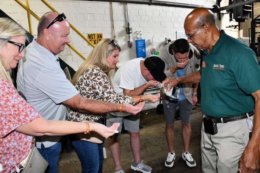 Guests taste and smell unaged whiskey before it gets barrelled