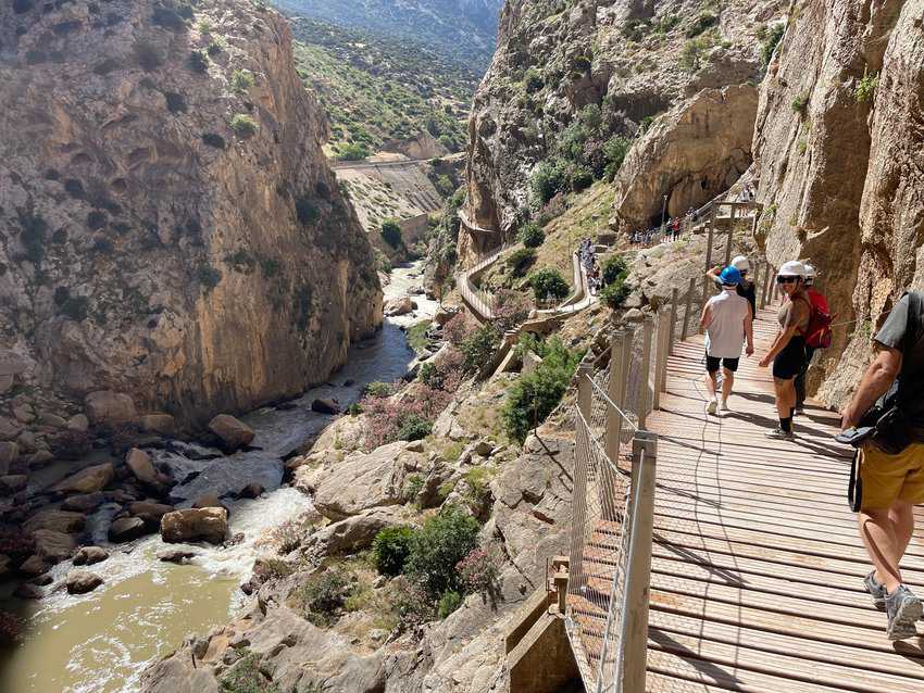 The hike winds around the sides of a mountain, everyone hikes in the same direction.