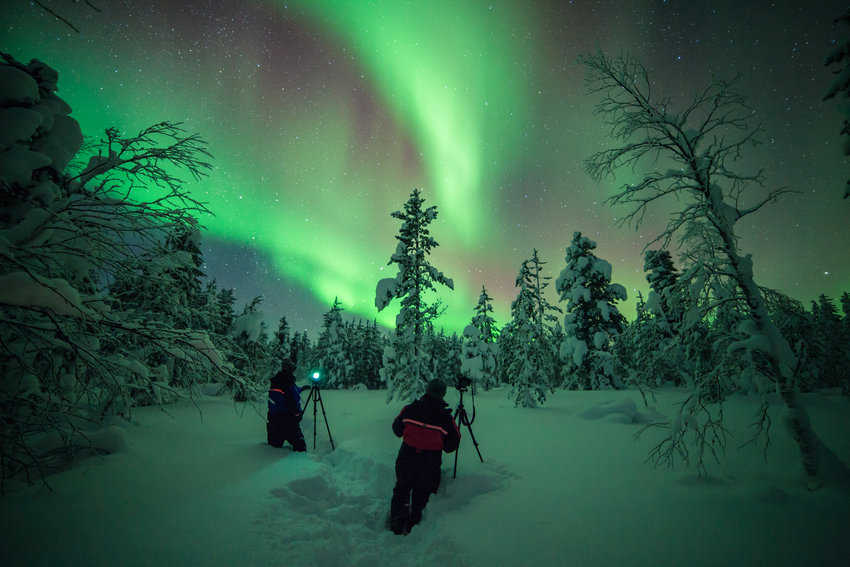 Photographers capturing the full brilliance of the lights (Photo by Antti Pietikainen)