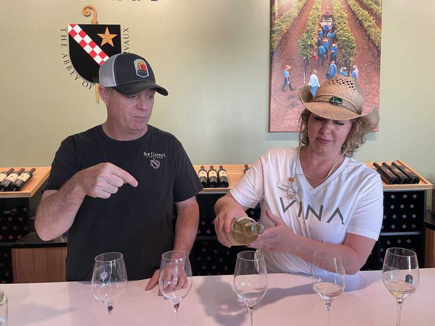 Joh Adams, general manager at New Clairvaux Winery, watches as one of his favorite vintages is poured in the tasting room in downtown Redding.