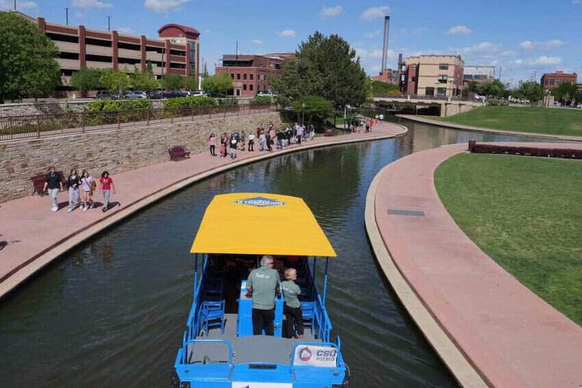 People and boats on Pueblo's Riverwalk