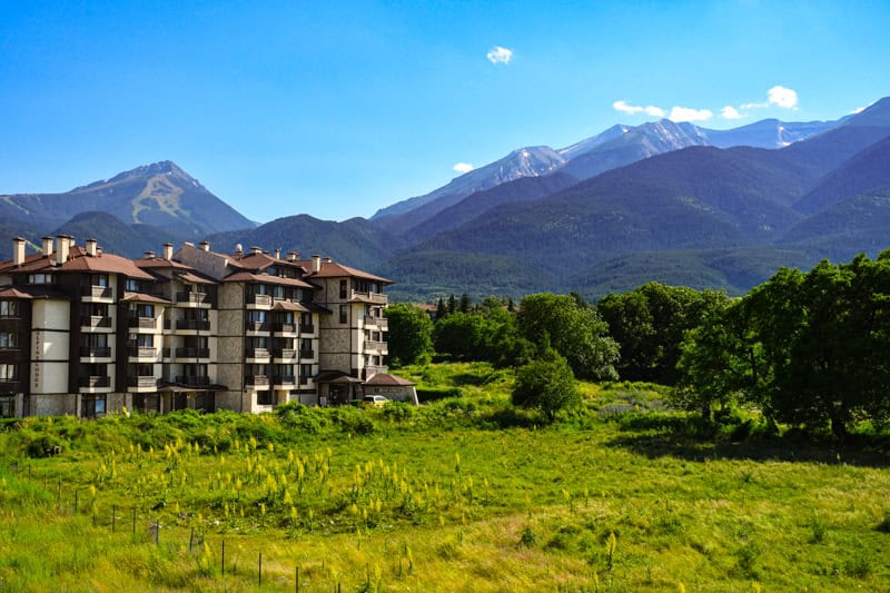 Green mountain scenery and the landscape of Bansko in summer. Pirin Mountains in the background. ©Envato