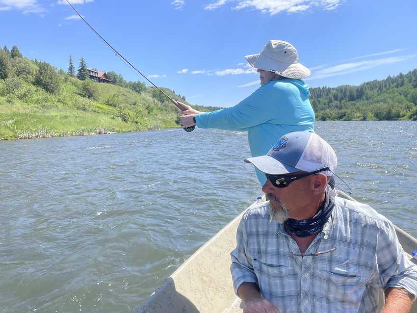 Diane Crabtree wets a line on the Snake River with some guidance from Skip Wallen, a guide at Three River Ranch. Photo by Anne Braly