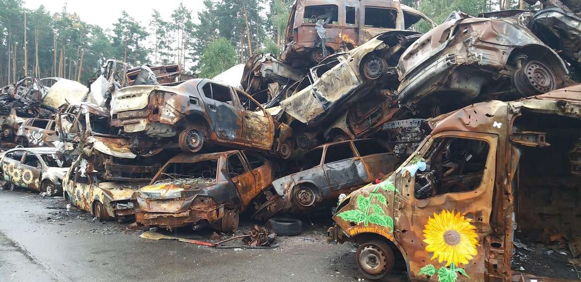 The Car Cemetery in Irpin (just outside of Kyiv), which was formed when Ukrainians were forced to abandon their vehicles and flee advancing Russian forces on foot after Ukrainians strategically destroyed an overpass. After Kyiv was liberated, it was turned into an art installation.