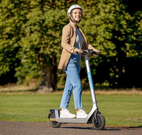 A woman rides a Bird e-scooter. Photo from Bird media kit