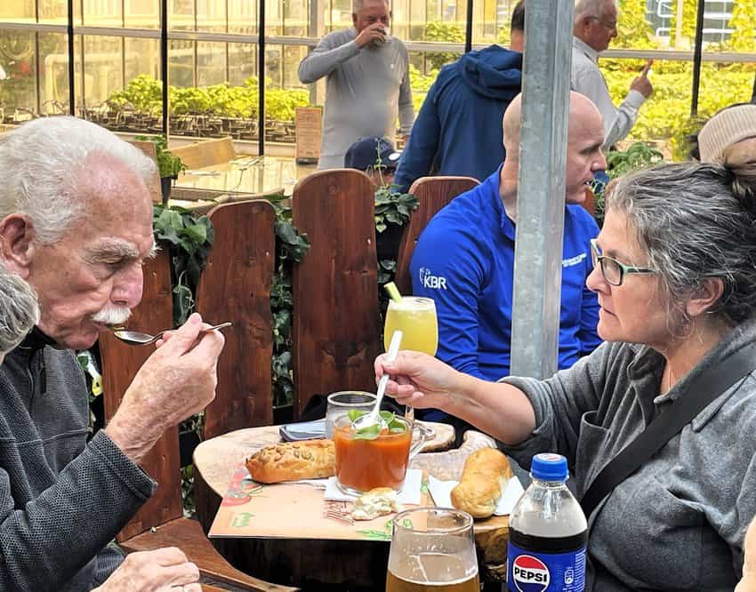 A couple shares a warm mug of homemade tomato soup on a chilly day at Fridheimar. 