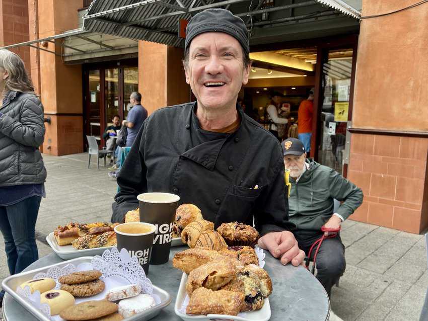 Da Silva Nels Dias, pastry chef at Market Hall Bakery, greeting us outdoors with an overloaded tray of fresh pastries outside the bakery.