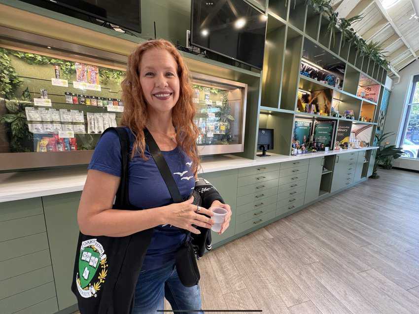 Image of Dale Sky Jones, who provided a tour of the Root’d in 510 Cannabis Distillery, showcasing wall displays of products in the spacious showroom.