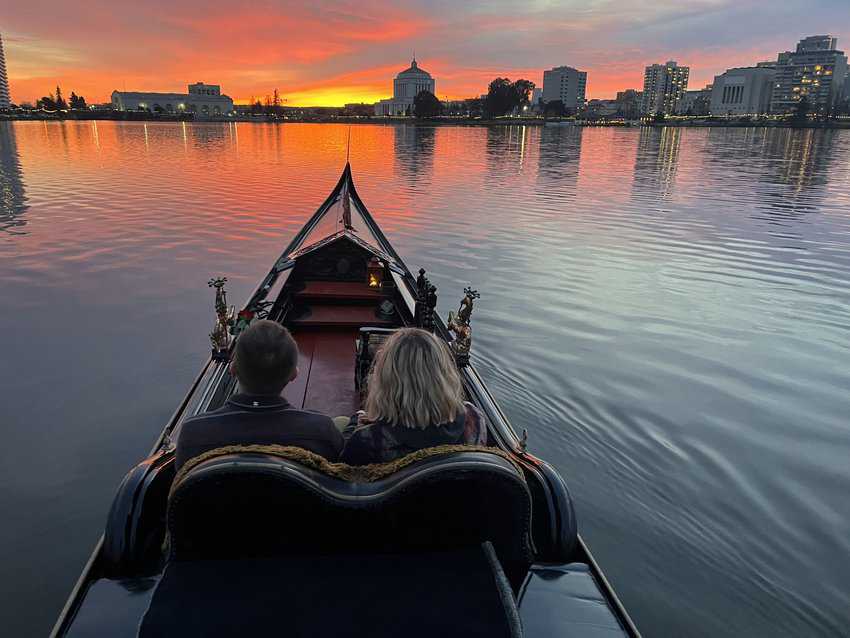 Beautiful sunset over Lake Merritt, capturing a romantic gondola ride with vibrant colors reflecting on the water.