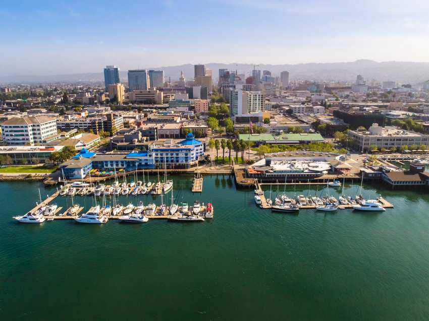 Stunning aerial view of Jack London Square, showcasing the vibrant waterfront, bustling docks, and surrounding urban landscape.