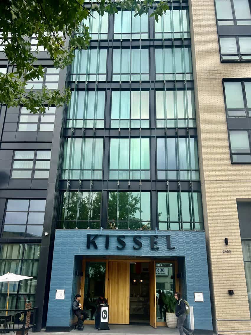 Kissel Uptown, a tall hotel reflecting the urban vibe of the area, boasts a modern industrial design with sleek lines and contemporary architecture.