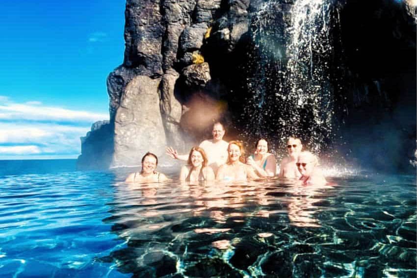 A group enjoys a warm soak in the large pool at Sky Lagoon.